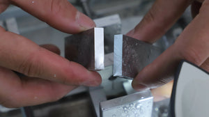 Aluminum block cut with the ToAuto smart metal cutting saw, showing precise low-splash cutting for metal parts